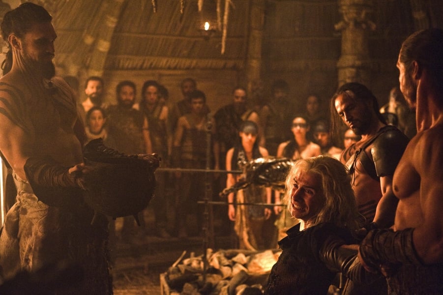 Caption = Drogo's "crowning" of Viserys by pouring molten gold onto his head was acclaimed by critics.